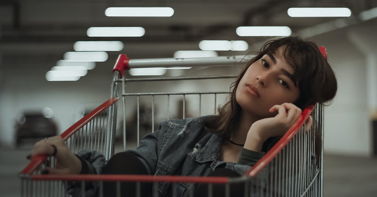 Are there underground mobs in peaceful difficulty? - Dreamy female with black hair and head tilted to side with hand near face sitting in metal cart while looking at camera on blurred underground parking lot Are there underground mobs in peaceful difficulty? - Dreamy female with black hair and head tilted to side with hand near face sitting in metal cart while looking at camera on blurred underground parking lot