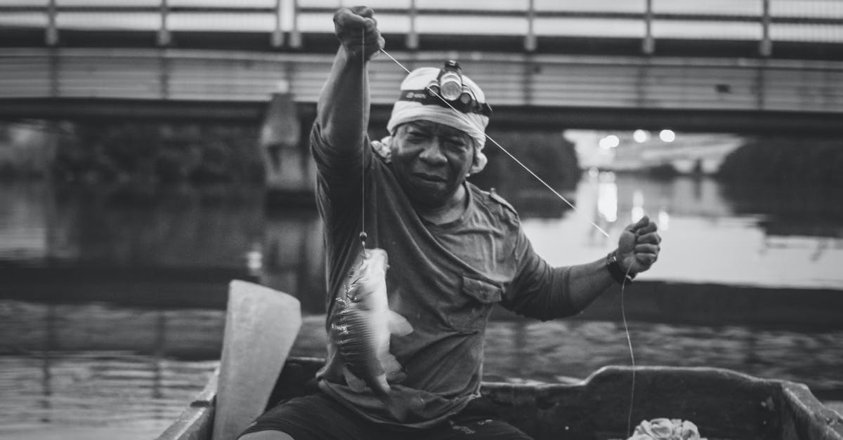 Are there ways to make catching legendary fish easier? - Grayscale Photo of a Man Catching Fish