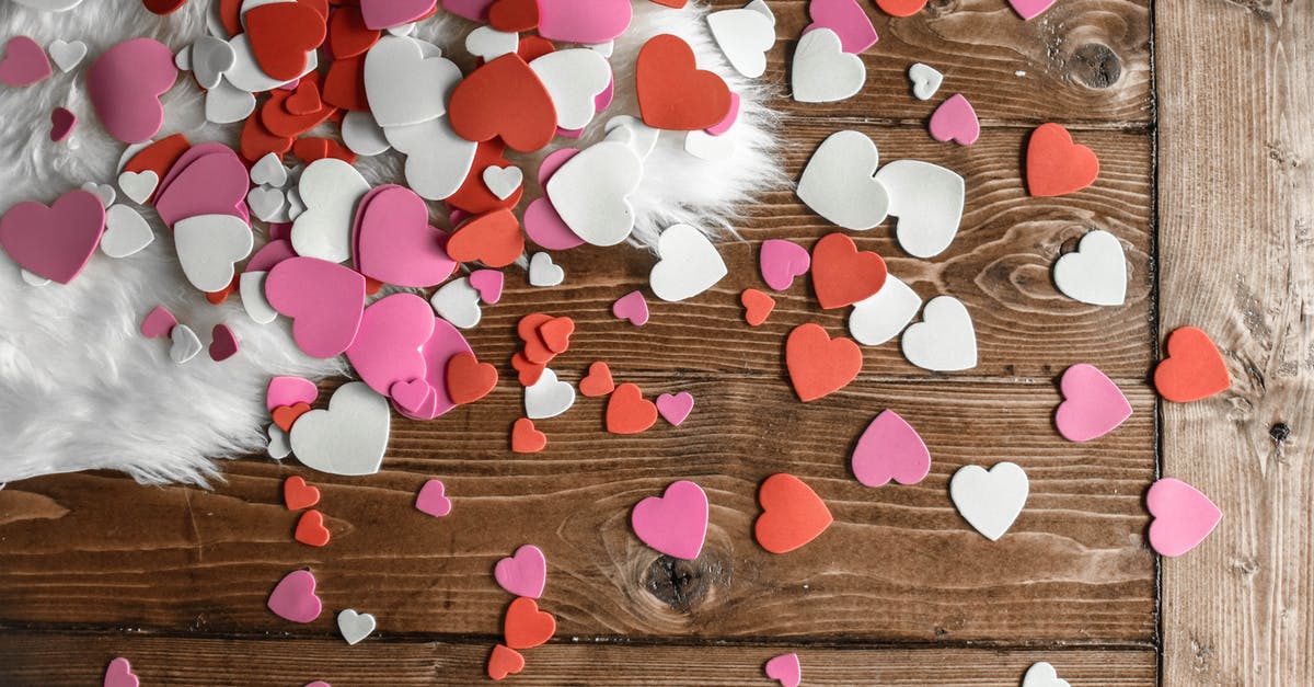 Are toad's spots red or white? - Top view of red white and pink heart shaped confetti of paper placed on wooden floor and white carpet