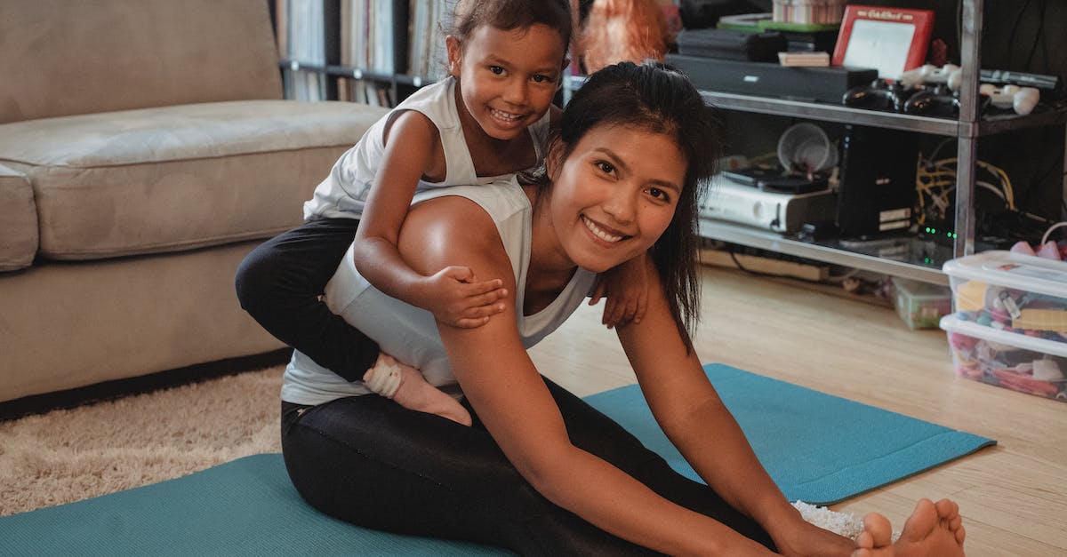 Are trained abilities passed to offspring via breeding? [duplicate] - Happy ethnic mother stretching body and piggybacking adorable daughter while sitting on mat at home and looking at camera
