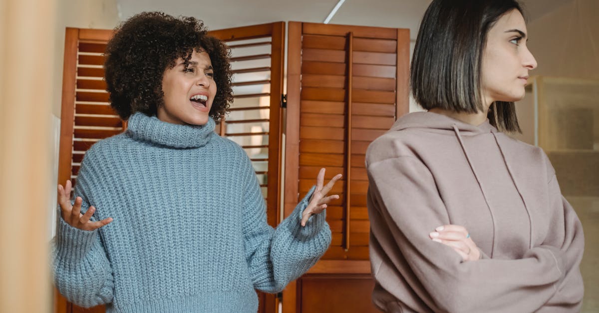 Are you supposed to ignore the adds in boss fights? - Furious African American female with black hair screaming while fighting with displeased female in light room with wooden folding screen