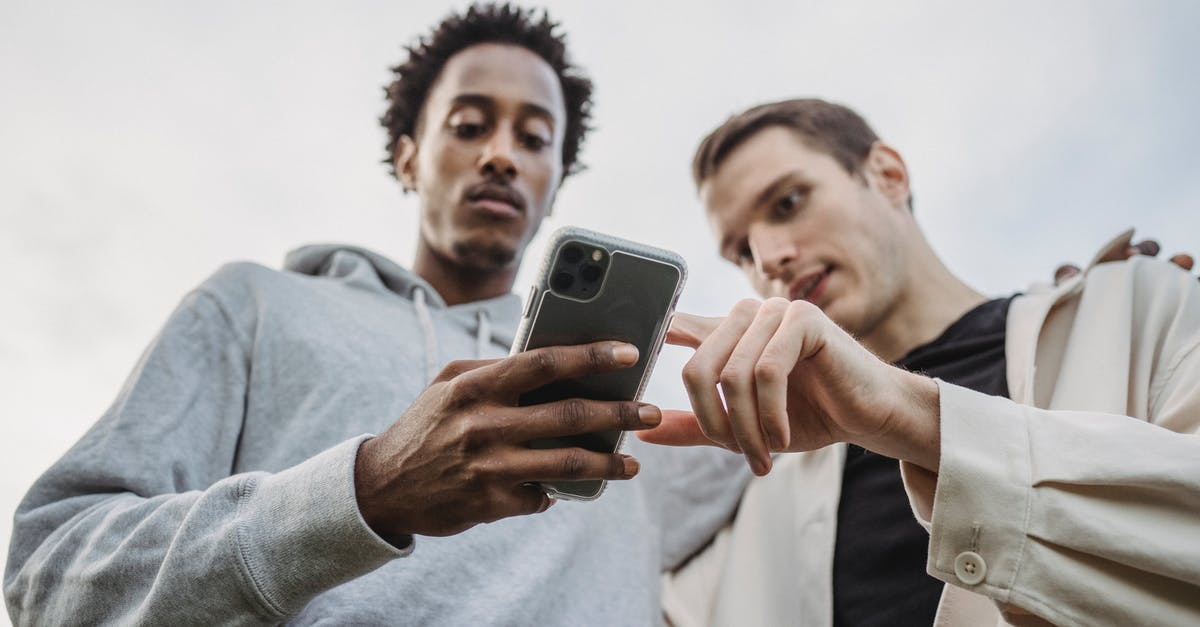 At what point will the turret benefit from Molten Core - Multiethnic friends browsing smartphone together outside At what point will the turret benefit from Molten Core - Multiethnic friends browsing smartphone together outside