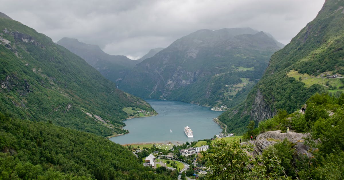 At what range do ships enter "combat"? - Breathtaking scenery of small village located on shore of mountainous island covered with green trees and plants under overcast sky