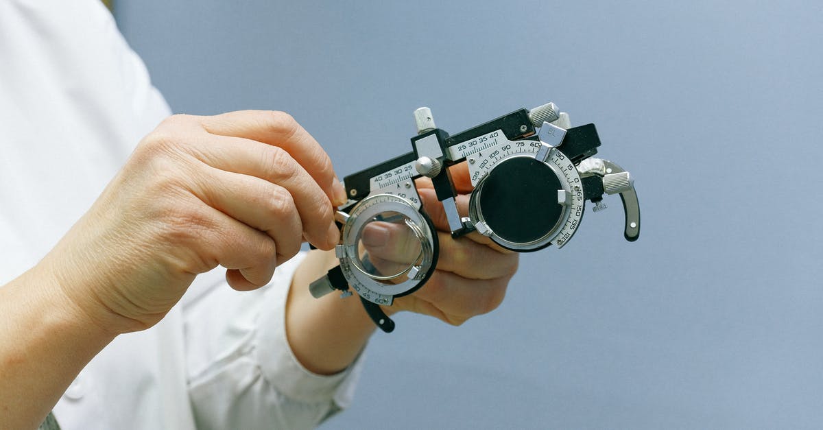 At what range will a pokemon show up? - Crop anonymous medic showing ophthalmic device