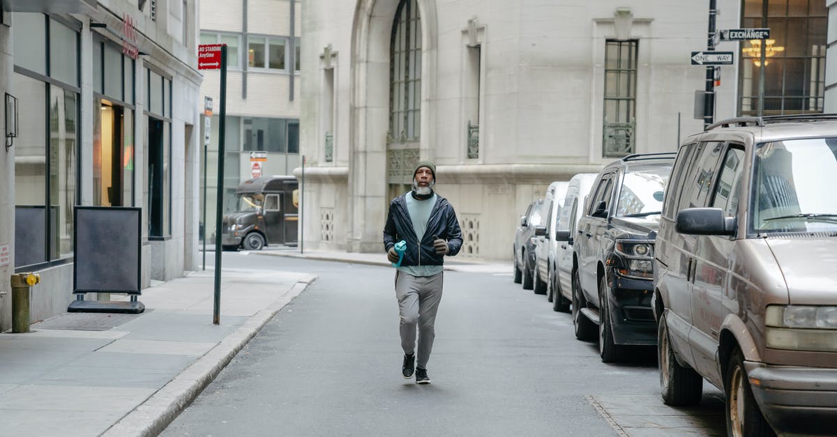 At what speed am I walking? [duplicate] - African American man with fitness bottle walking along parked cars