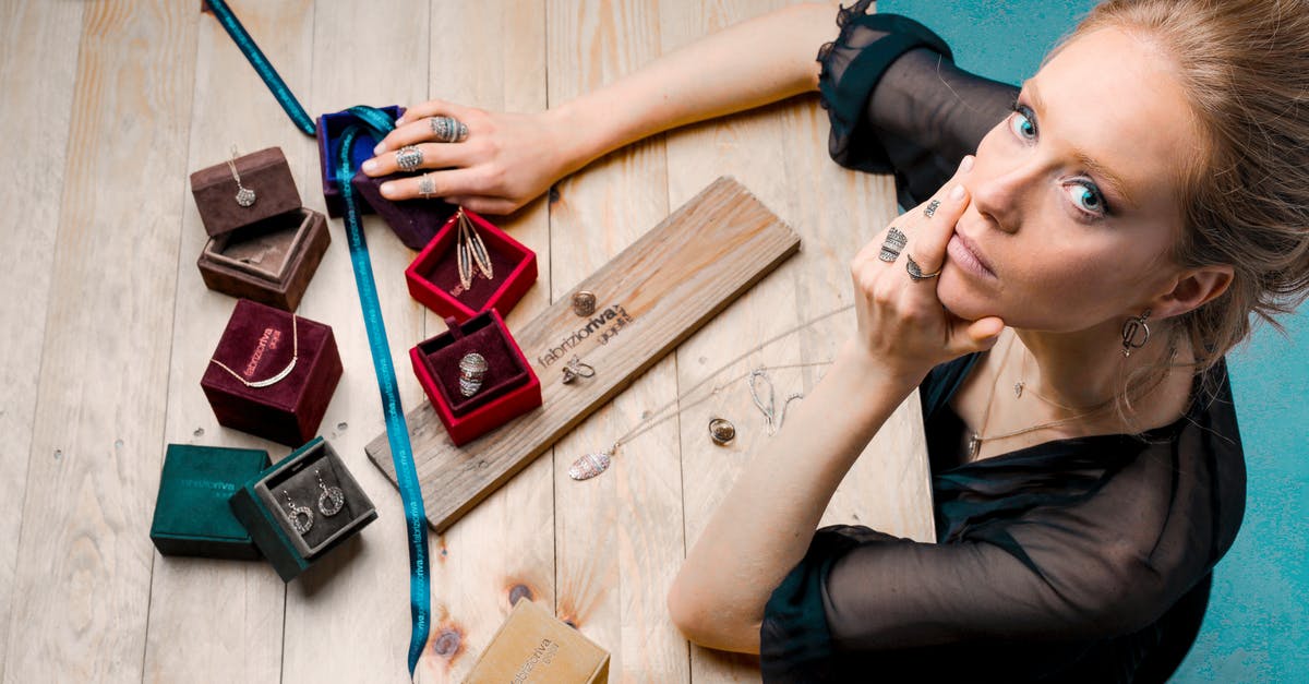 Attempting to launch Mass Effect 1's Startup Utility with little success - From above serious businesswoman looking up at camera while sitting at wooden table with small jewelry boxes with bijouterie and decorating with ribbon as present Attempting to launch Mass Effect 1's Startup Utility with little success - From above serious businesswoman looking up at camera while sitting at wooden table with small jewelry boxes with bijouterie and decorating with ribbon as present