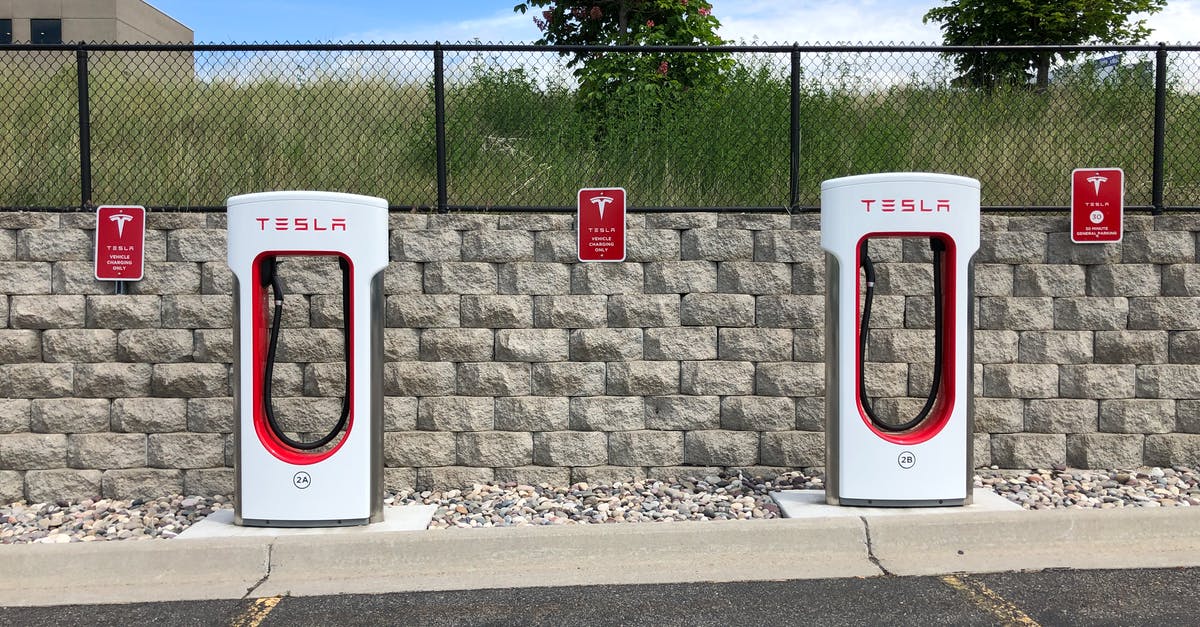 Auto-dismissed plot text - Two White and Red Tesla Charging Station Auto-dismissed plot text - Two White and Red Tesla Charging Station