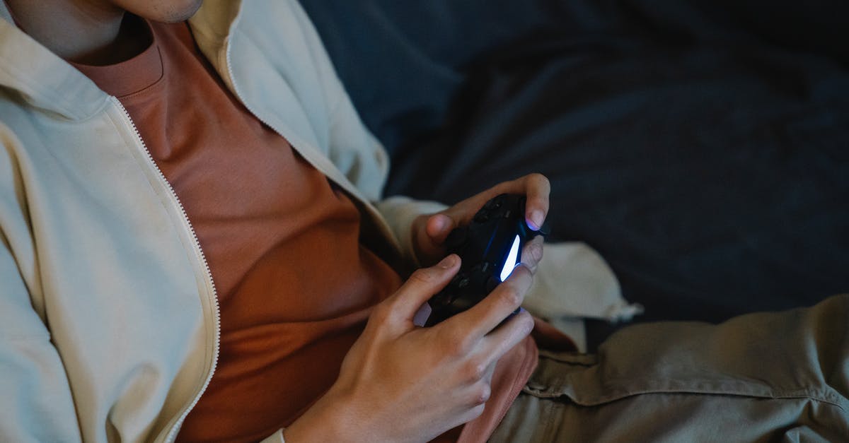 Autohotkey: How to map a keystroke to a controller button press - Crop gamer with joystick playing video game on sofa Autohotkey: How to map a keystroke to a controller button press - Crop gamer with joystick playing video game on sofa