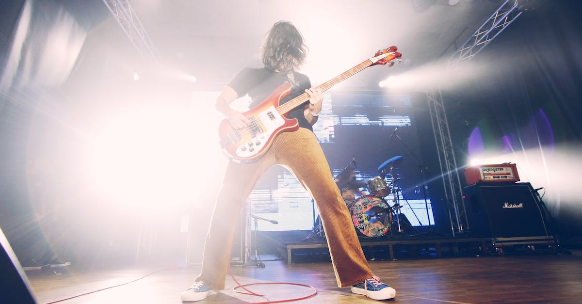 Average performance in ESO with my setup - Woman in White Tank Top Playing Brown and White Stratocaster Electric Guitar