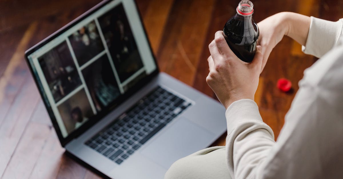 Baking soda inside PlayStation 4 - Crop person with soda sitting on floor with laptop Baking soda inside PlayStation 4 - Crop person with soda sitting on floor with laptop
