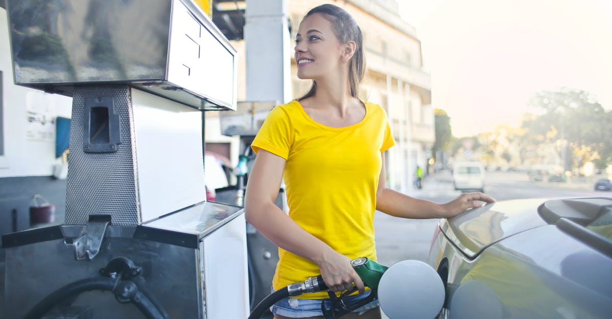 Balloon out of gas but won't accept fuel - Woman in Yellow Shirt While Filling Up Her Car With Gasoline Balloon out of gas but won't accept fuel - Woman in Yellow Shirt While Filling Up Her Car With Gasoline