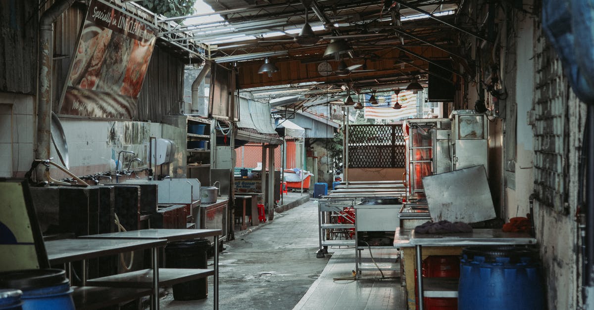 Banner Saga - Only 2 armor damage? - Interior of abandoned cafeteria with tables shelves and banner and lamps hanging on destroyed roof located on street of town