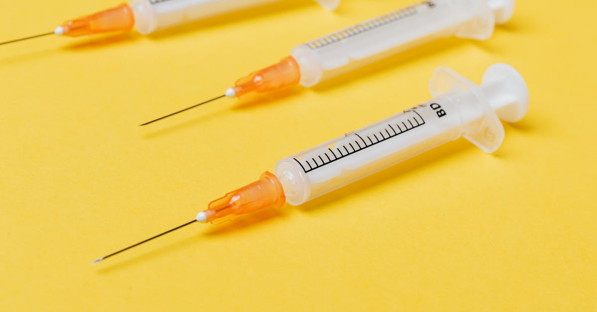 Barrel used as stash is no longer neutral - Empty syringe injectors on yellow background Barrel used as stash is no longer neutral - Empty syringe injectors on yellow background