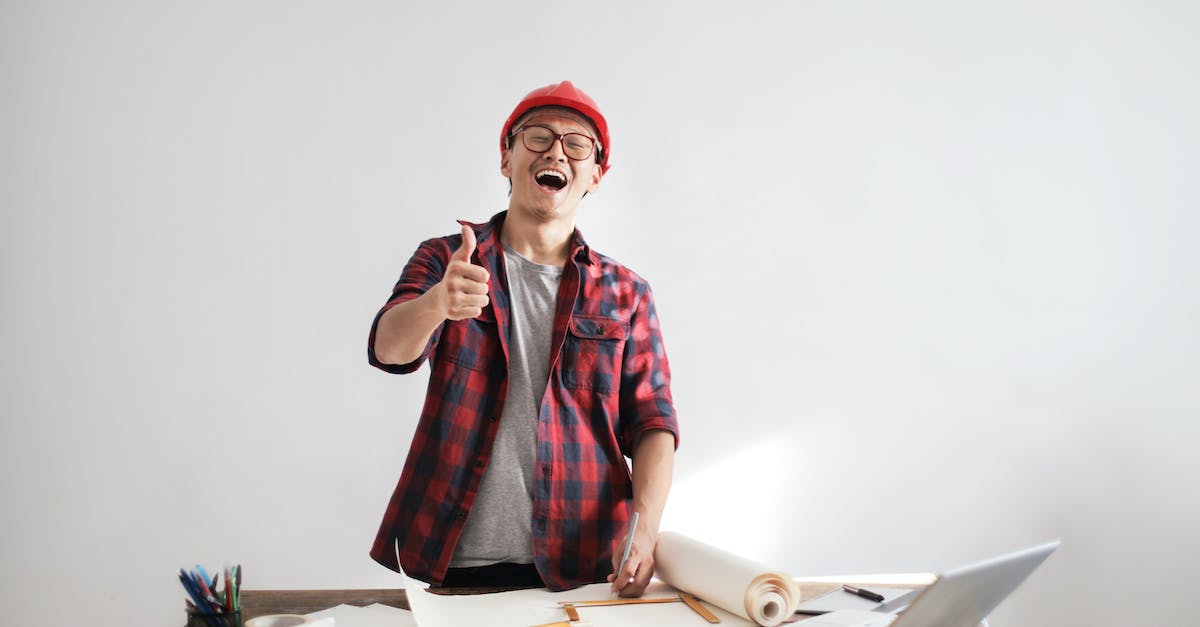 Basic attack strategy for Civilization 5 - Laughing male constructor showing thumb up at working desk
