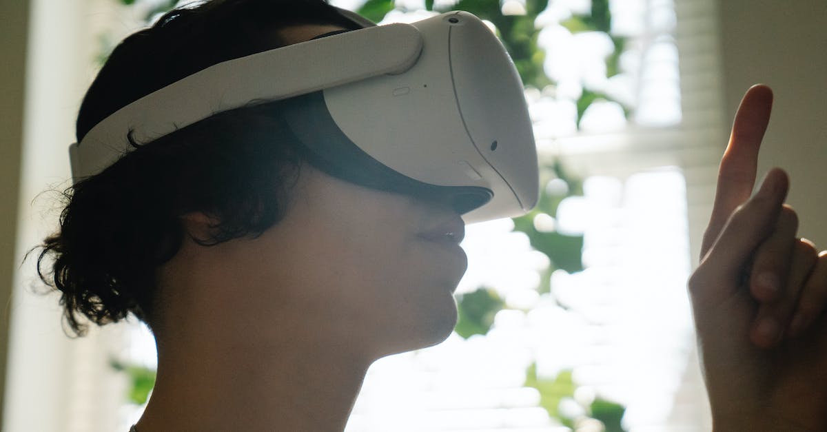 Batman Arkham City Augmented Reality (PC) - Amazed young guy exploring cyberspace in VR headset Batman Arkham City Augmented Reality (PC) - Amazed young guy exploring cyberspace in VR headset