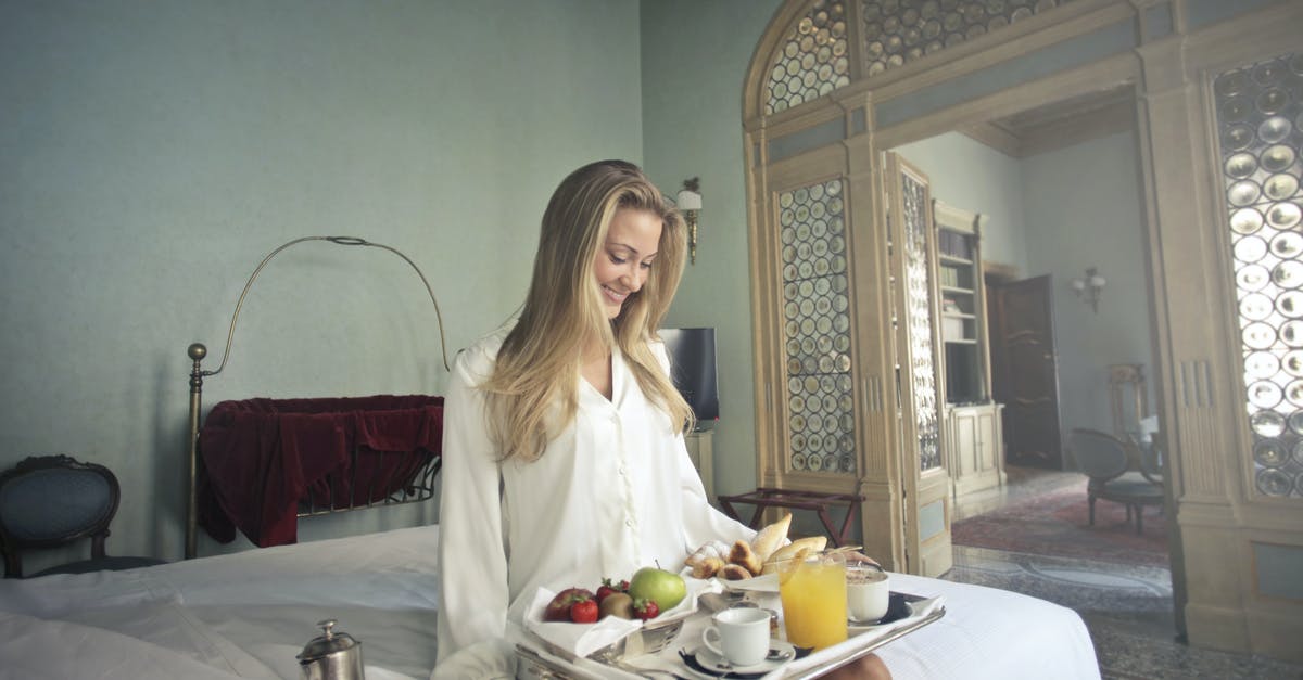 Battle.net Launcher on Wine Linux - Windows Secondary Logon service error - Cheerful woman with breakfast on tray in hotel bedroom