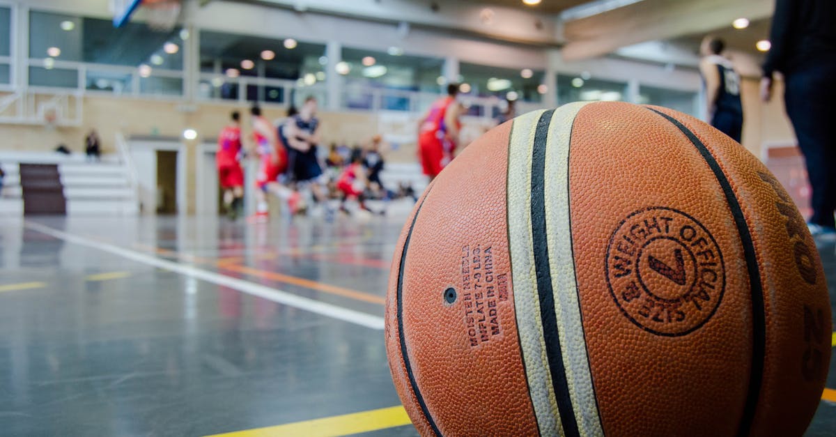 Battling at a gym simultaneously with other players - Brown Basketball on Grey Floor