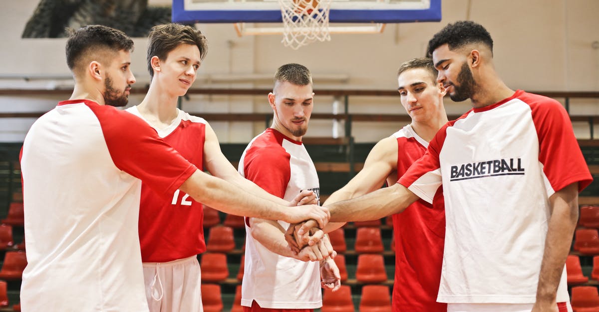 Battling at a gym simultaneously with other players - Group of Men Playing Basketball