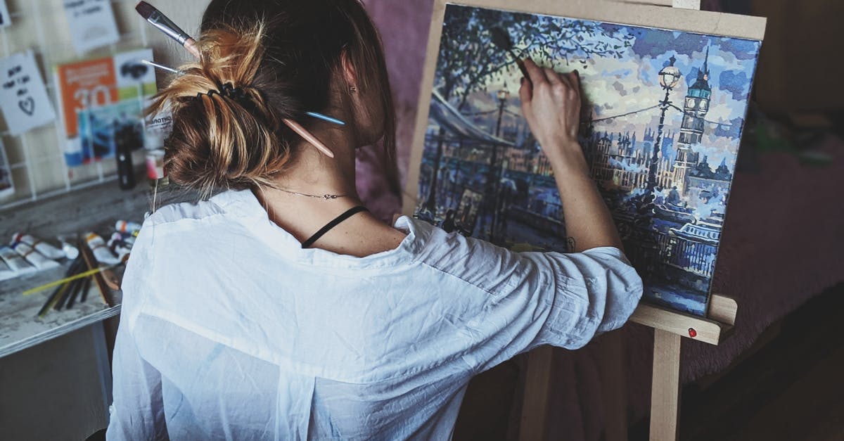 Benefit of creating puppets? - Photo Of Woman In Front Of Painting