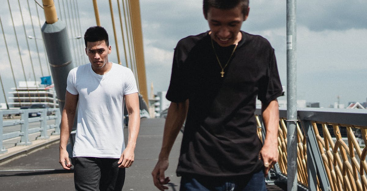 Best way to utilize cake - Young Asian men walking on asphalt bridge Best way to utilize cake - Young Asian men walking on asphalt bridge