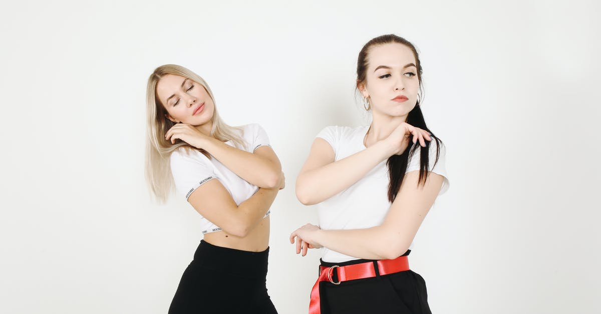 Binding Multiples Keys for the same action - Slim thoughtful young female friends in similar clothes dancing and touching hair while standing near white wall and expressing dance style Binding Multiples Keys for the same action - Slim thoughtful young female friends in similar clothes dancing and touching hair while standing near white wall and expressing dance style