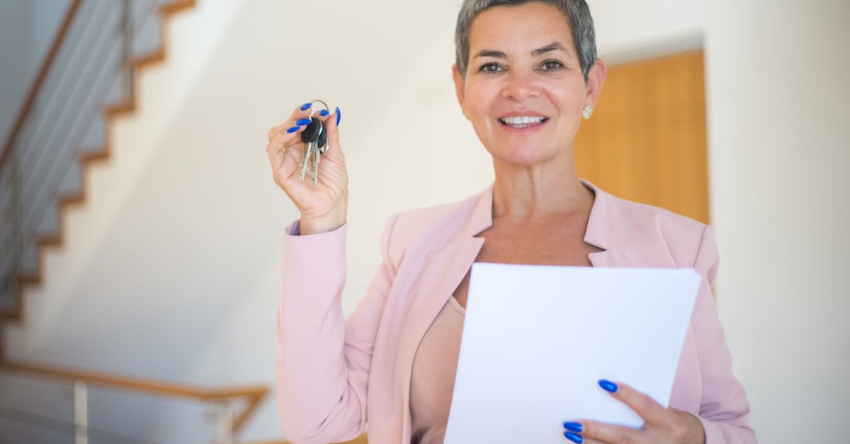Binding Special Keys - Woman in Pink Long Sleeve Shirt Holding White Paper Binding Special Keys - Woman in Pink Long Sleeve Shirt Holding White Paper