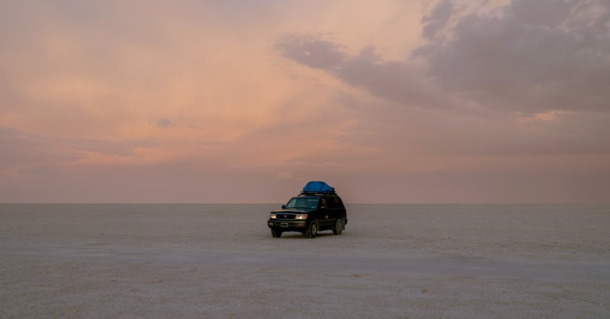 Black Desert Linking Nodes - Lonely black automobile driving through empty sandy desert against cloudy sky in sunset