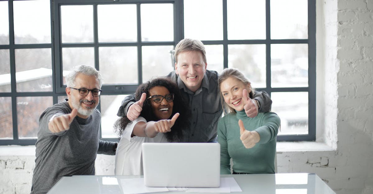 Black ops 2 dlcs download and install but doesn't show up - Cheerful diverse coworkers of different ages working on laptop on project while showing thumb up gesture and smiling when looking at camera