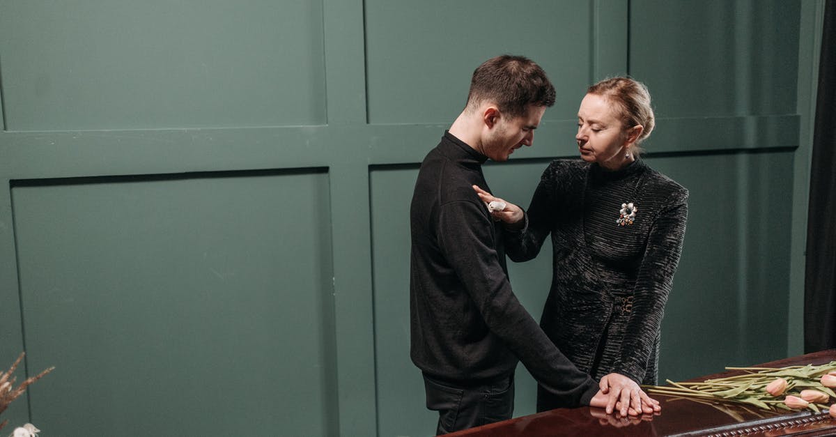 Black widow perk output - Man and Woman Standing Near the Coffin