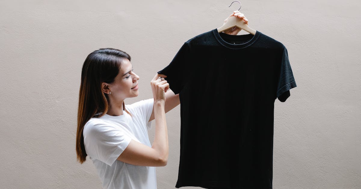 Bloodskal Barrow won't appear - Side view of positive female wearing casual outfit standing with black shirt against gray background