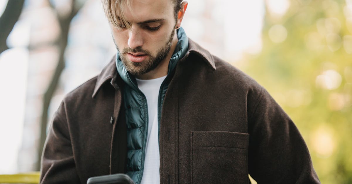 Bought call of the forsaken collectors edition, did not get items? - Young hipster looking at smartphone screen in park