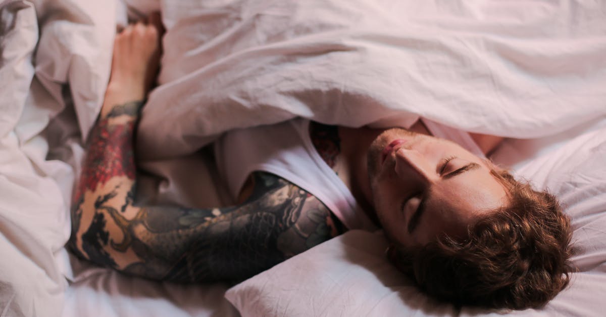 Brainwashed or sleeper agents - Woman Lying on Bed With Tattoo on Her Body Brainwashed or sleeper agents - Woman Lying on Bed With Tattoo on Her Body