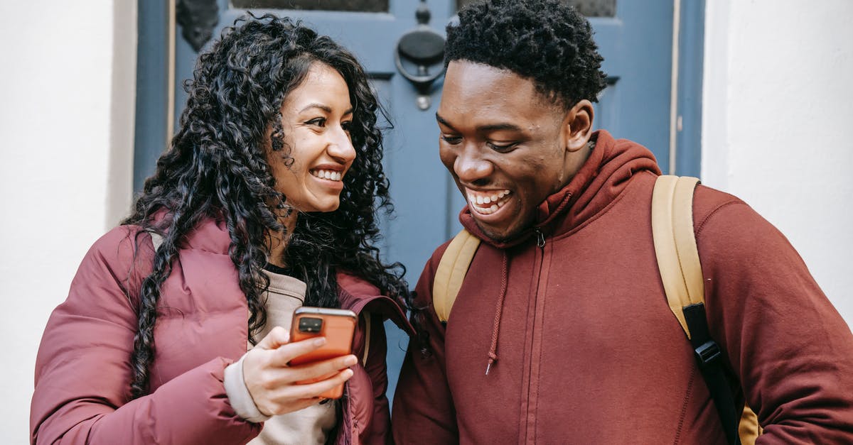 Branching dialogue in minecraft using a player scoreboard, a trigger, tellraw, and a command block chain? - Young happy multiethnic partners talking while browsing internet on cellphone in town in daytime