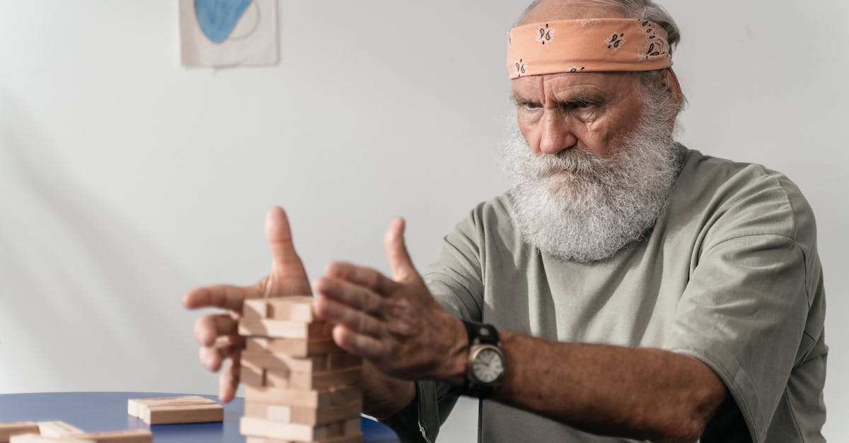 Breaking 2 blocks with each click? - Man in Gray Crew Neck T-shirt Wearing Brown Cap Breaking 2 blocks with each click? - Man in Gray Crew Neck T-shirt Wearing Brown Cap