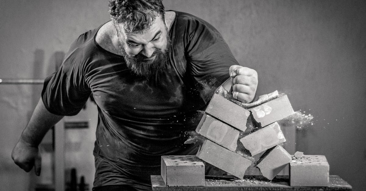 breaking blocks [duplicate] - A Man Breaking Concrete Block Using His Hand