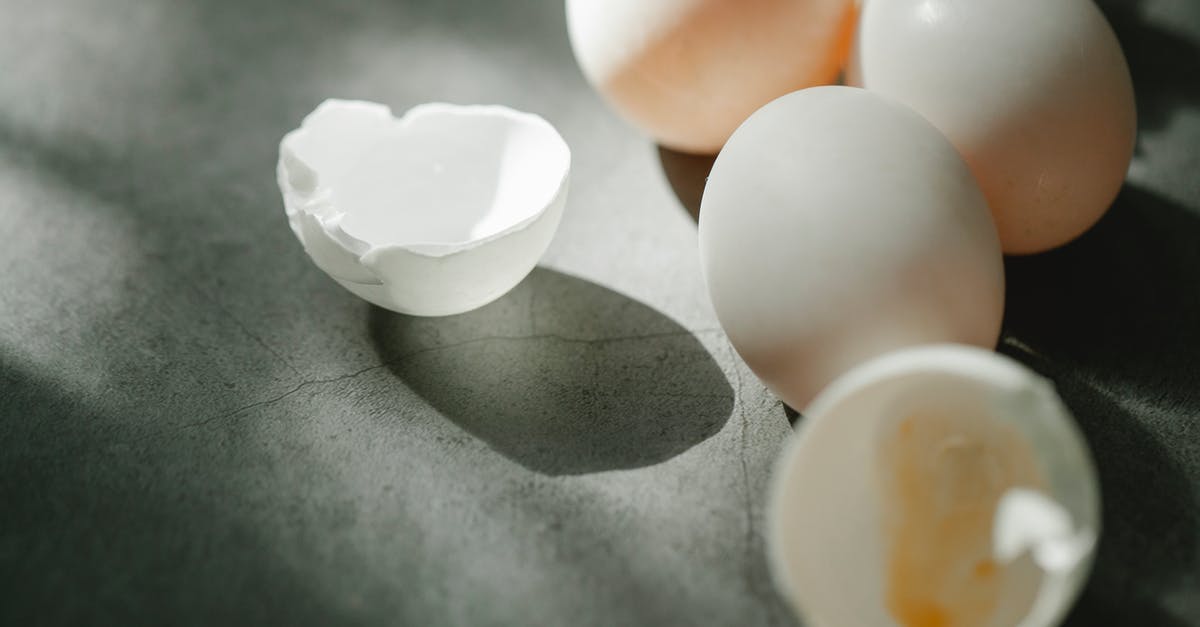 Broken Age, how to get the yellow egg from bird by the clowd shoes place - From above of fresh raw white chicken eggs with broken shells scattered on gray table in kitchen