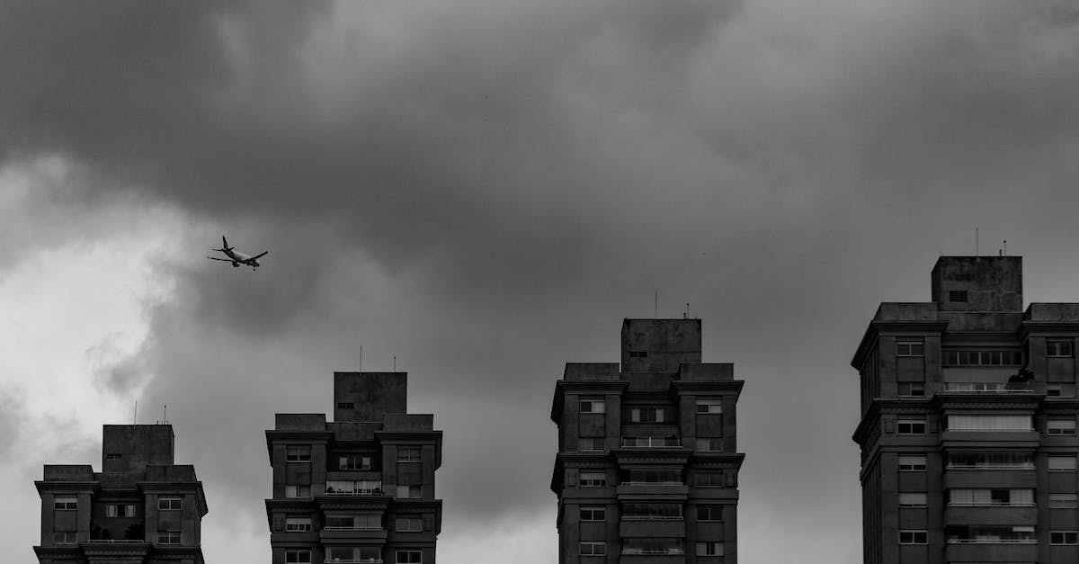 Build a plane or rocket for Kerbal high altitudes - Aircraft flying in thick clouds above city buildings