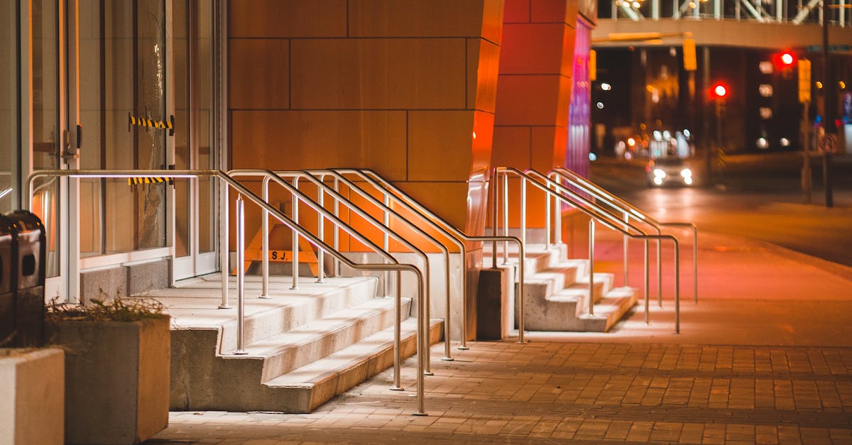 Building academy on oil tile - Auto acquire oil? - Illuminated staircase of contemporary house in town in twilight Building academy on oil tile - Auto acquire oil? - Illuminated staircase of contemporary house in town in twilight
