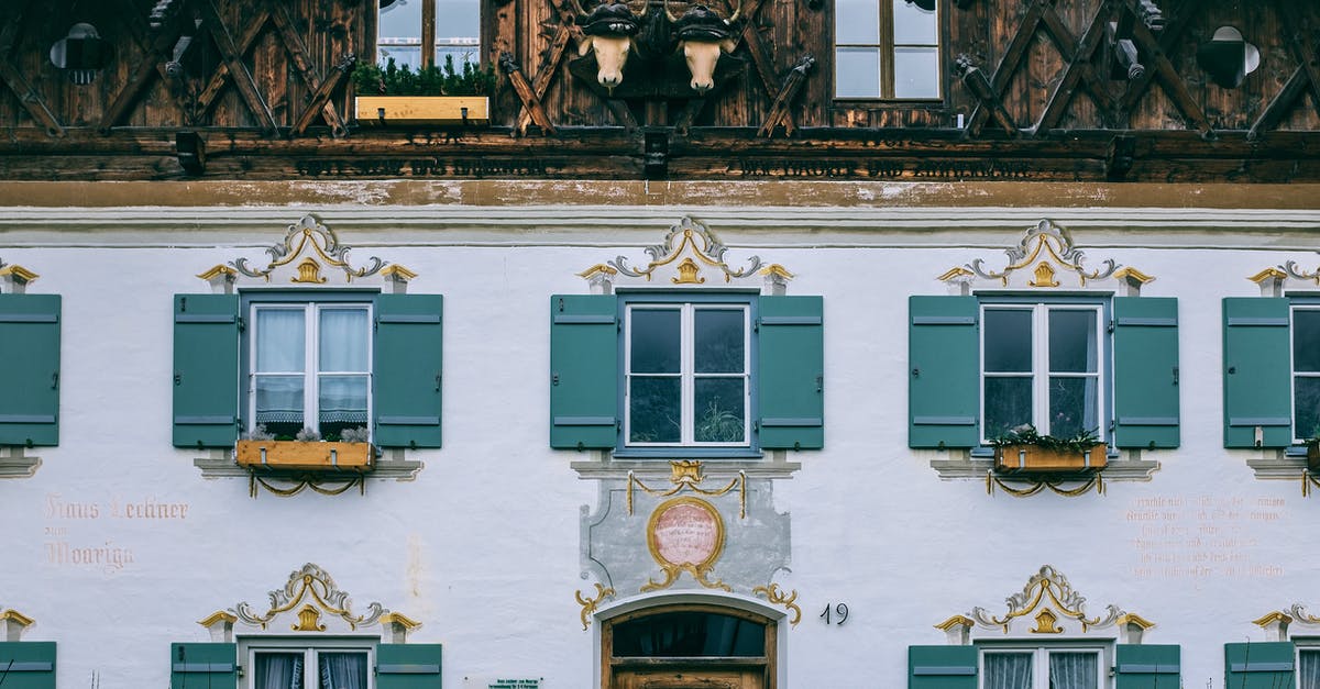 Building normally open floodgates - Exterior of old house with ornamental wall in city Building normally open floodgates - Exterior of old house with ornamental wall in city