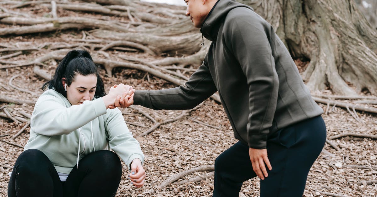 Bully Scholarship Edition: Unable to get the Nutcracker outfit - Ethnic man in sportswear helping overweight female with dark hair get up from ground in park in daytime Bully Scholarship Edition: Unable to get the Nutcracker outfit - Ethnic man in sportswear helping overweight female with dark hair get up from ground in park in daytime