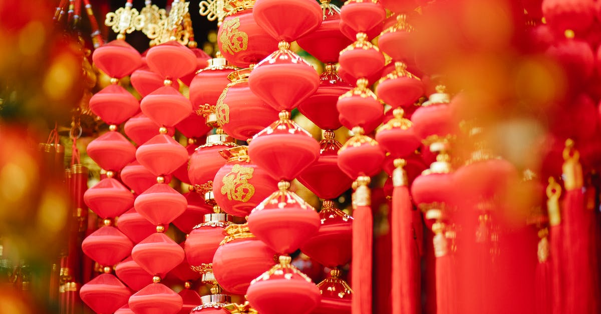 Buyers in Eve Regional Market - Red and golden Asian decorations hanging in local market