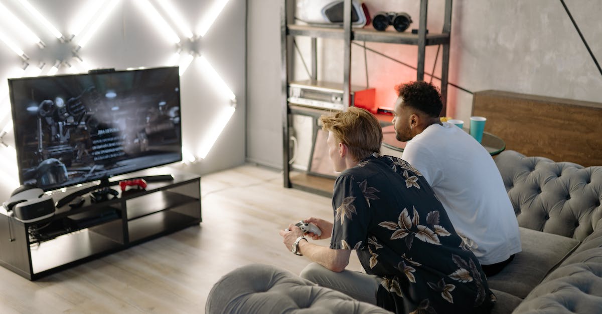 Buying localized Playstation 4 games in US Playstation Store - Woman in Black and White Floral Shirt Sitting on Gray Couch Buying localized Playstation 4 games in US Playstation Store - Woman in Black and White Floral Shirt Sitting on Gray Couch