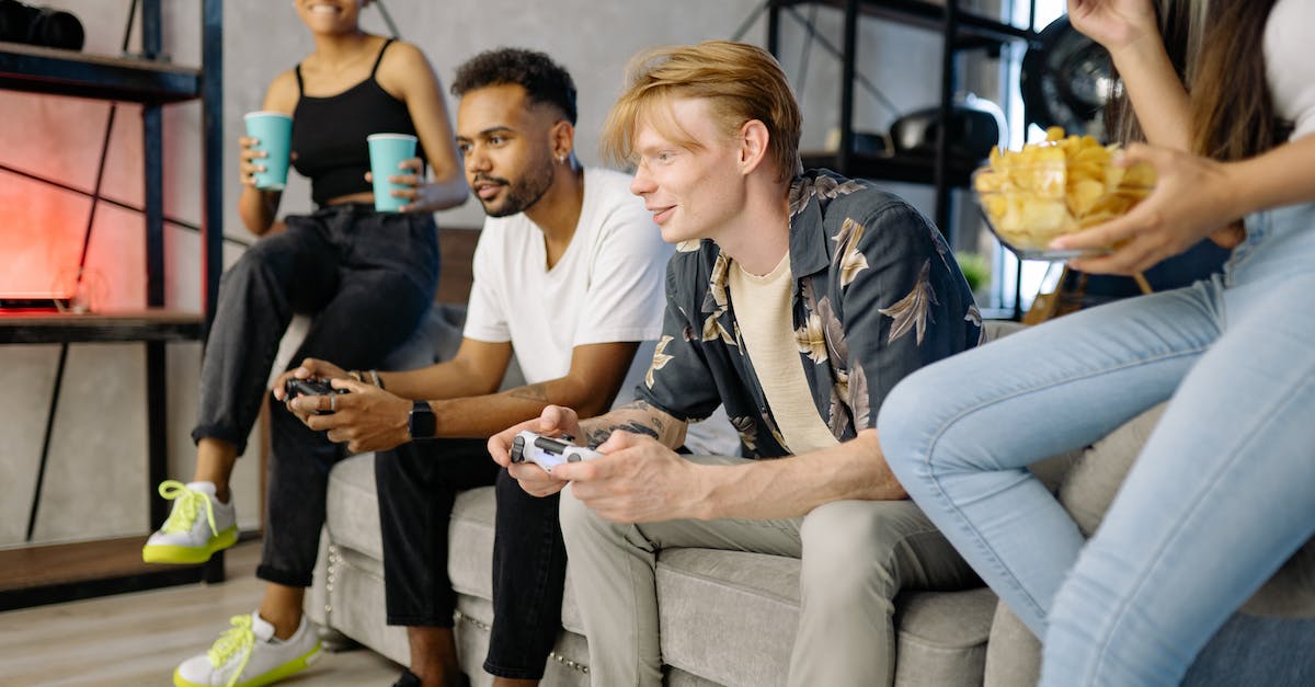 Buying localized Playstation 4 games in US Playstation Store - Woman in White Polo Shirt Sitting on Gray Couch Buying localized Playstation 4 games in US Playstation Store - Woman in White Polo Shirt Sitting on Gray Couch