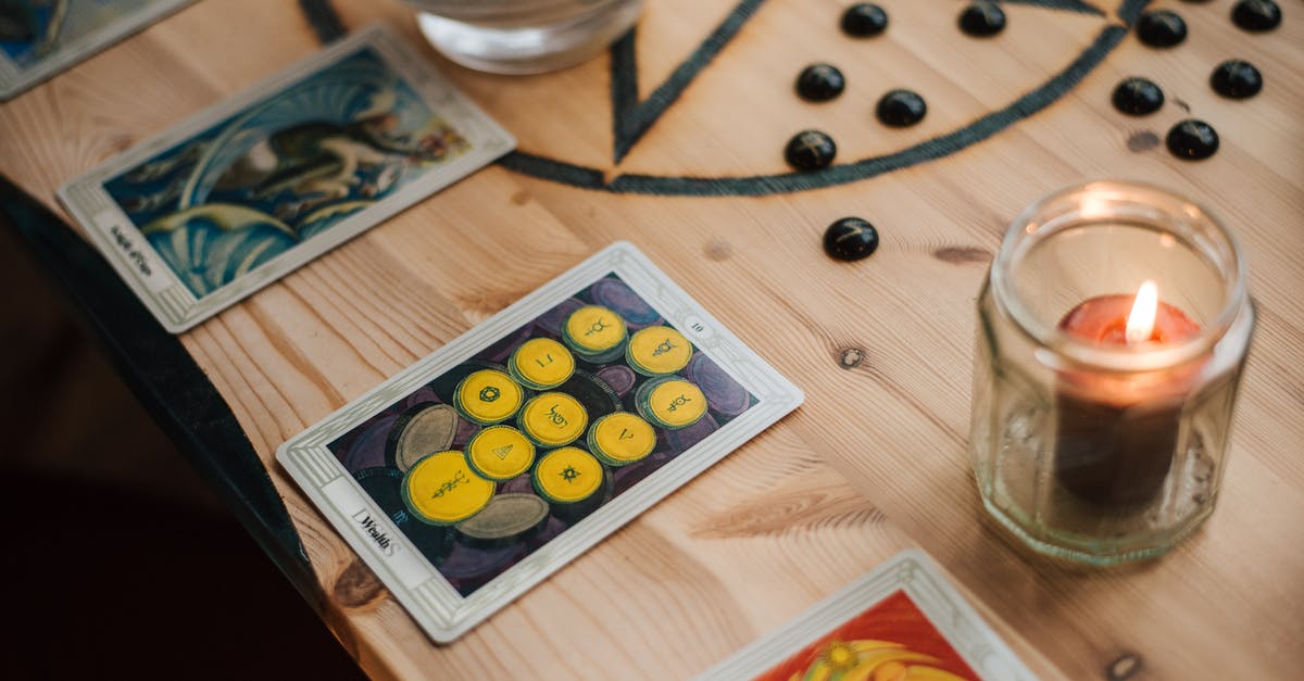 Buying the Full-Collection, do I get any card I haven't drawn yet, or 1 copy of any card from the core set? - From above of shiny candle in jar near bright tarot cards with illustrations on wooden table with oracle symbol