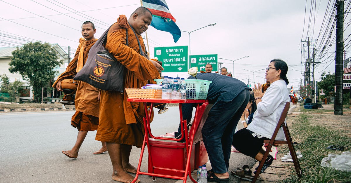 Buying Weapons in PvP - Woman in Brown Coat Standing Beside Red Chair