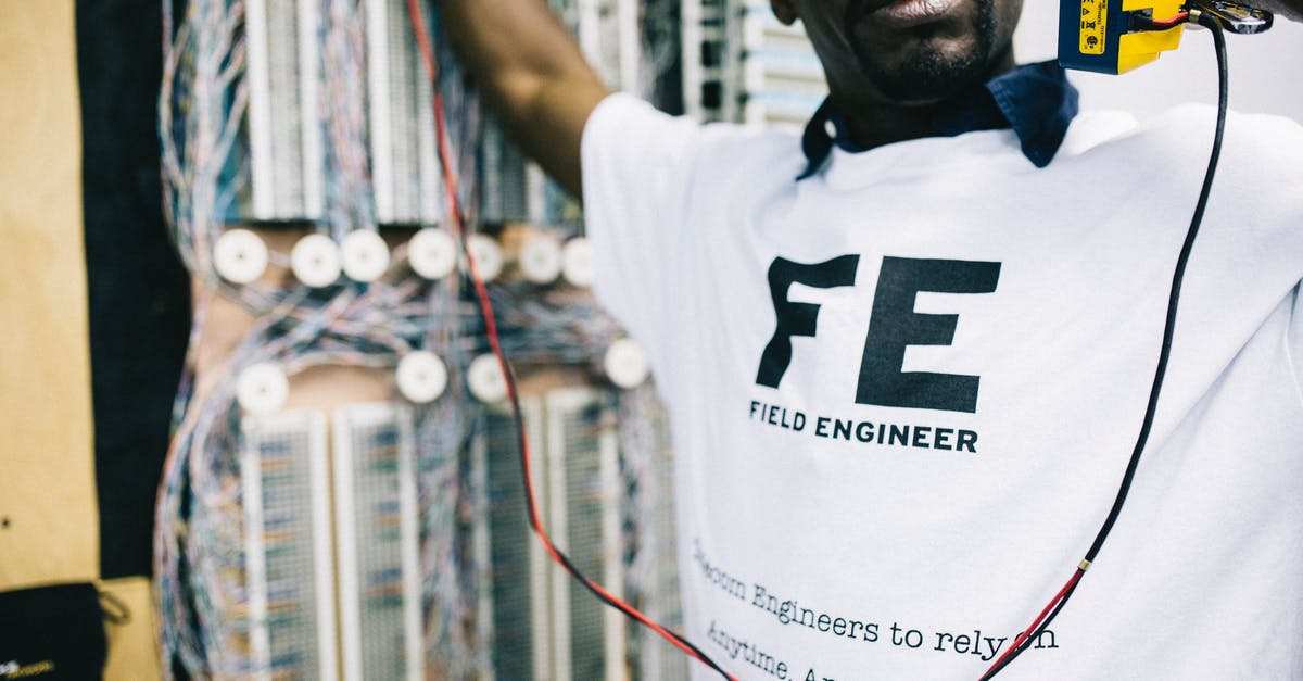 Call of Duty Advanced Warfare Controller Lag - Crop concentrated African American field engineer in white shirt standing near panelboard with handset and looking away
