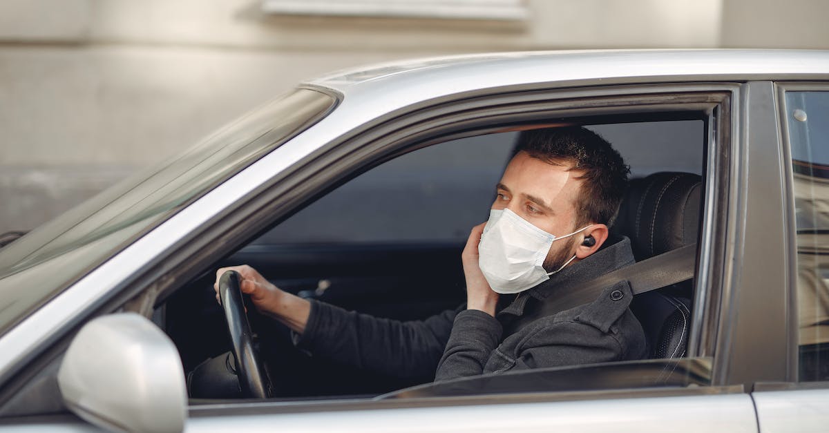 Call of Duty: World at War not launching - Serious bearded male driver wearing warm jacket and protective facial mask using wireless earphones sitting in auto with opened window during coronavirus pandemic Call of Duty: World at War not launching - Serious bearded male driver wearing warm jacket and protective facial mask using wireless earphones sitting in auto with opened window during coronavirus pandemic
