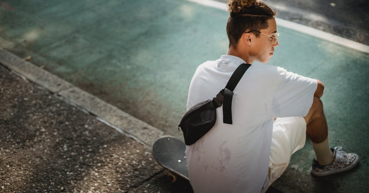 Can't break blocks when I change my gamemode back to survival [duplicate] - Back view of young ethnic male millennial with stylish hairstyle in white t shirt and shorts chilling on street sitting on skateboard after training