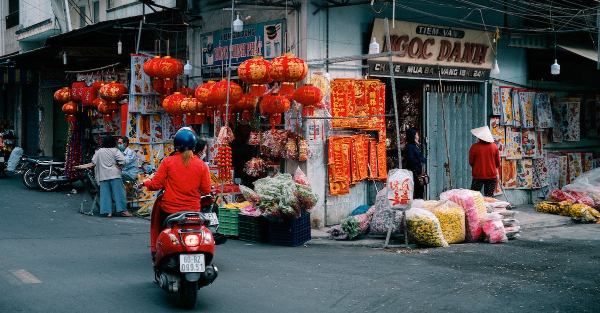 Can't get the merchant to spawn [duplicate] - Man in Blue Jacket Riding Red Motor Scooter