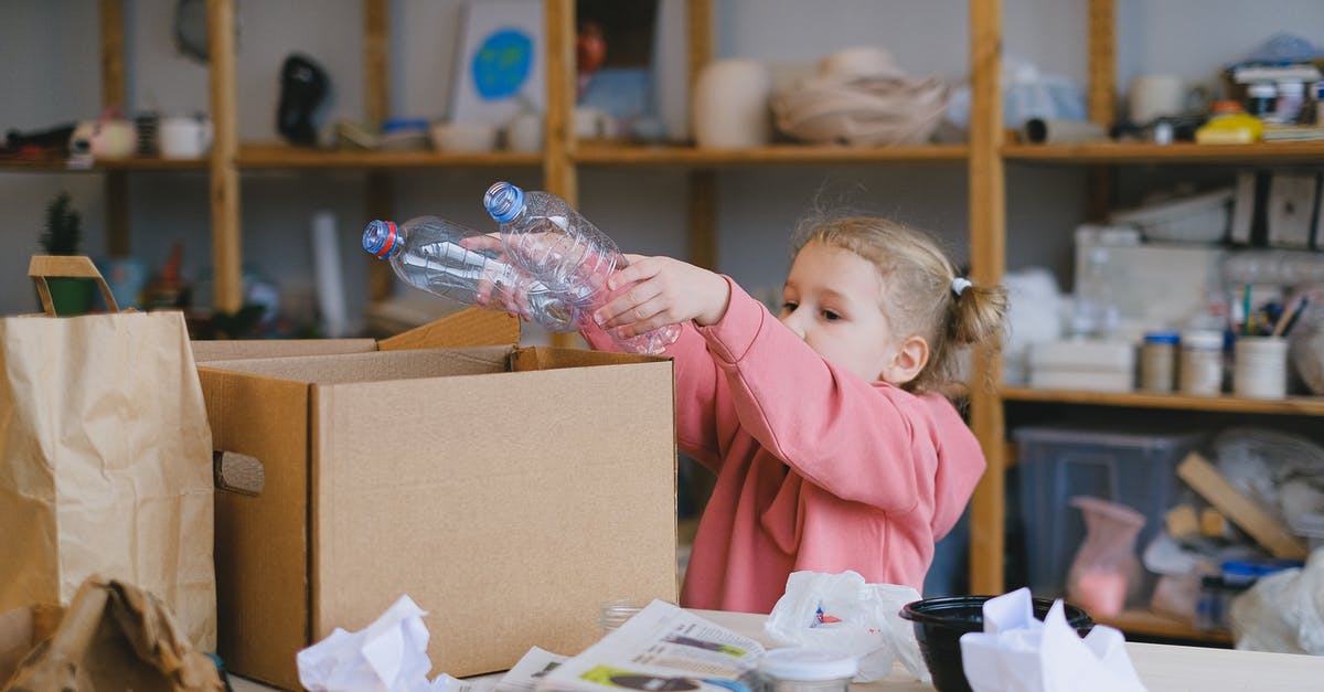 Can't get to treasure box items - A Girl Putting Plastic Bottles on a Cardboard Box